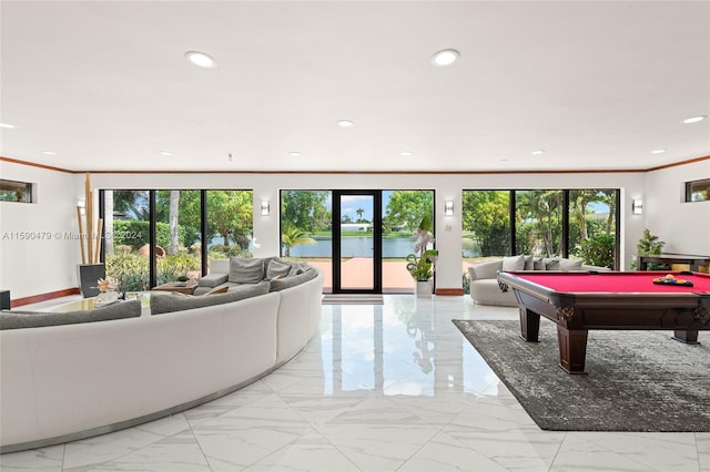 living room featuring ornamental molding, billiards, and a water view