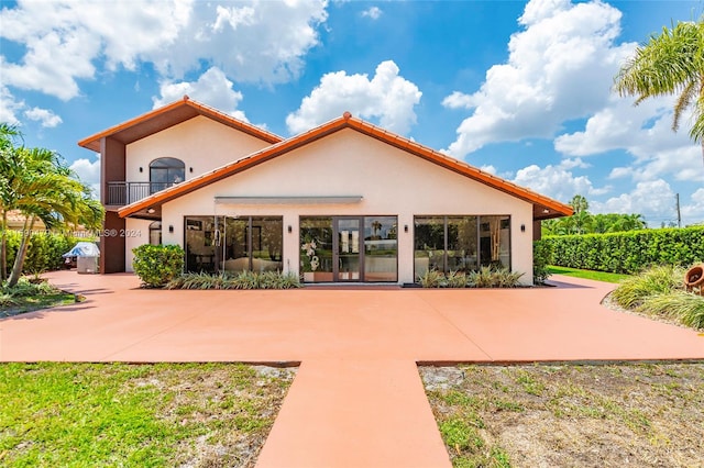 rear view of property featuring a balcony