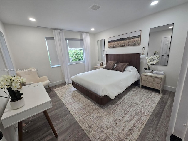 bedroom with dark wood-type flooring