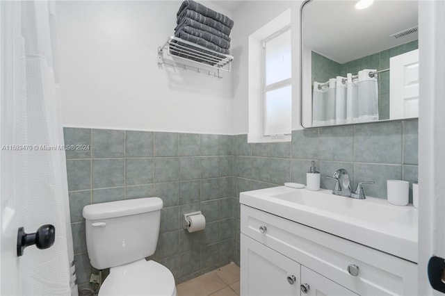 bathroom featuring tile patterned flooring, toilet, vanity, tile walls, and a shower with shower curtain