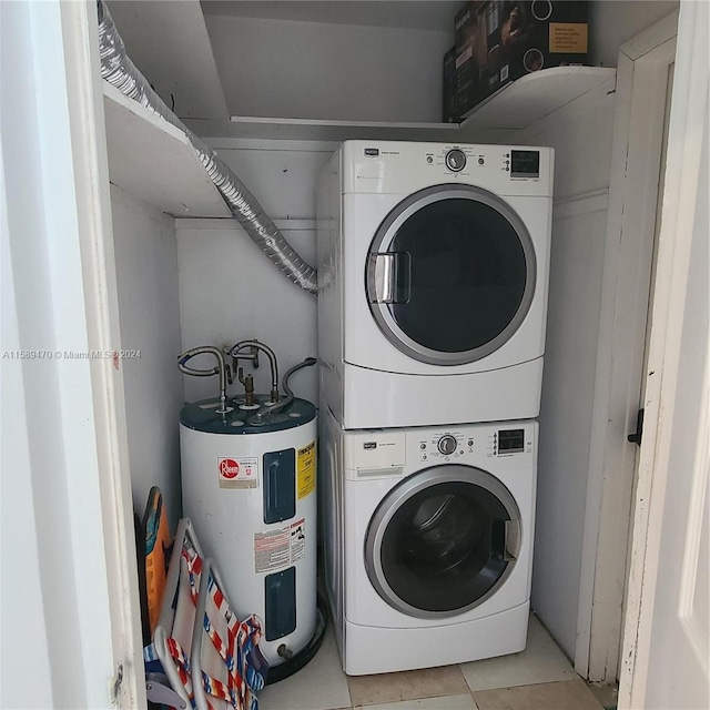 laundry area with water heater, light tile patterned floors, and stacked washing maching and dryer