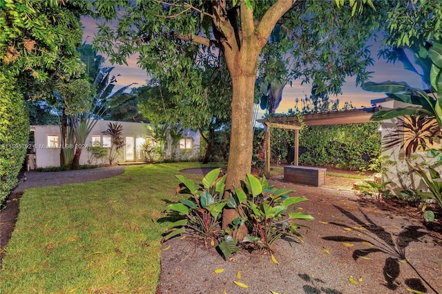 yard at dusk with a pergola