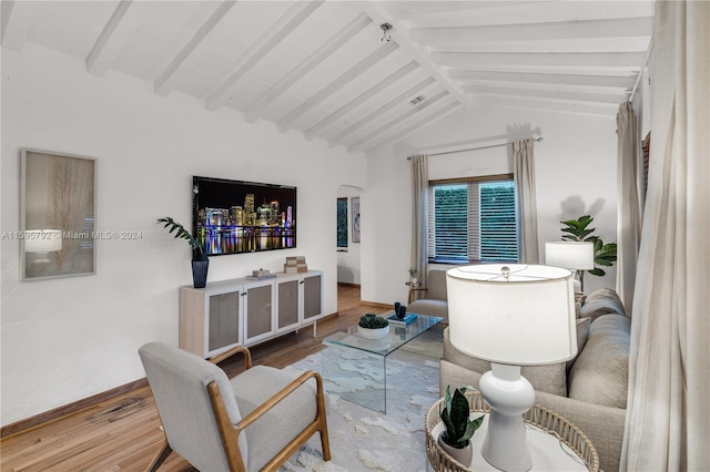 living room with vaulted ceiling with beams and hardwood / wood-style floors