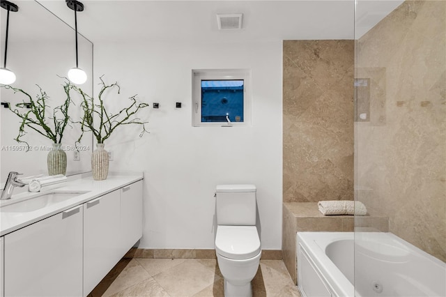 bathroom featuring vanity, tile patterned flooring, toilet, and a washtub