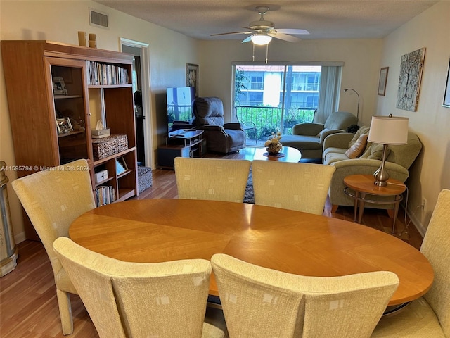 dining space featuring hardwood / wood-style flooring and ceiling fan