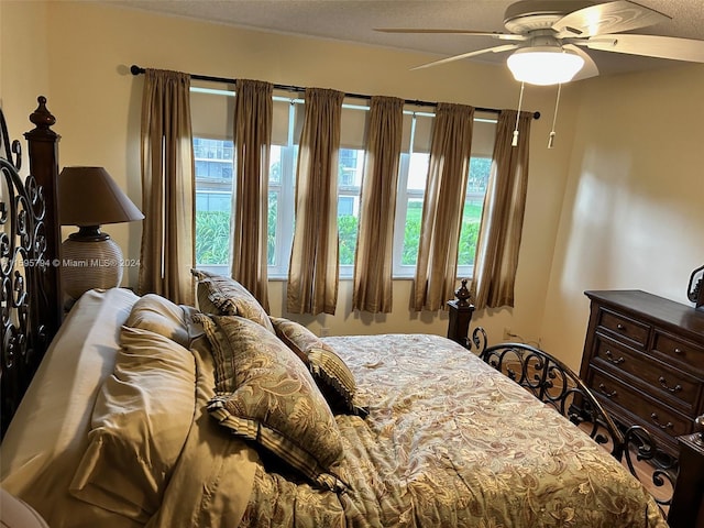 bedroom with ceiling fan and multiple windows