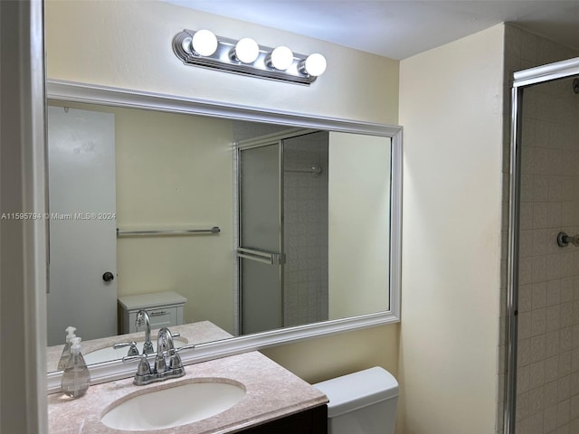 bathroom with vanity, an enclosed shower, and toilet