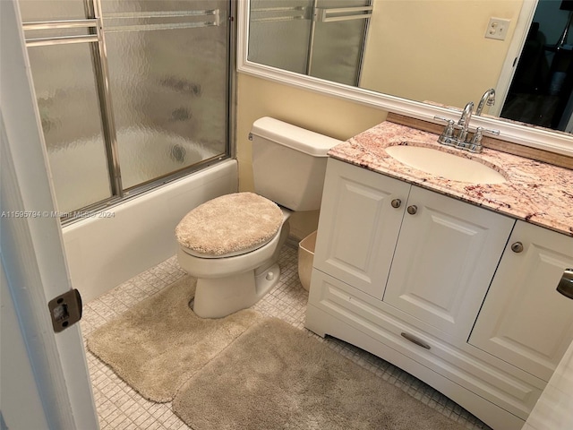 full bathroom featuring vanity, toilet, and bath / shower combo with glass door