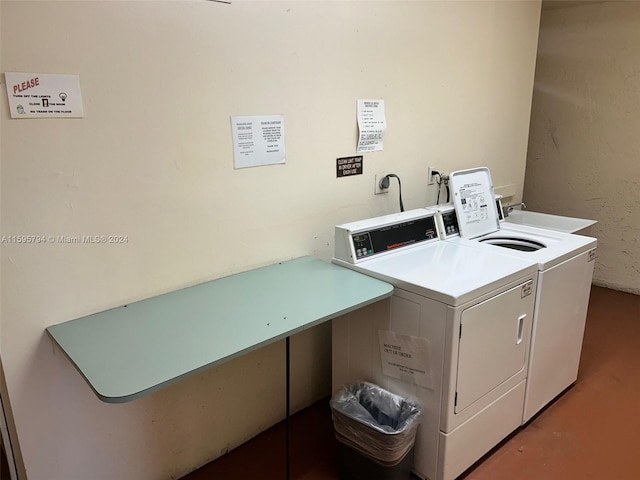 laundry area featuring washer and clothes dryer and sink