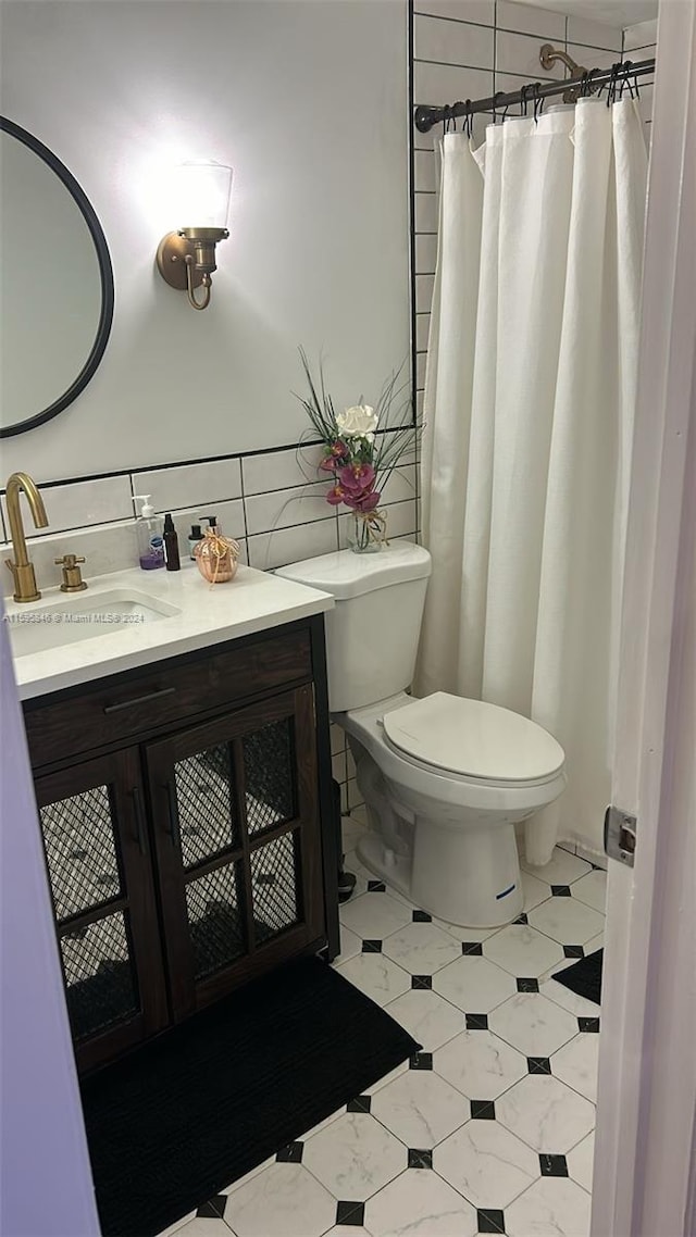 bathroom featuring tile floors, toilet, and vanity