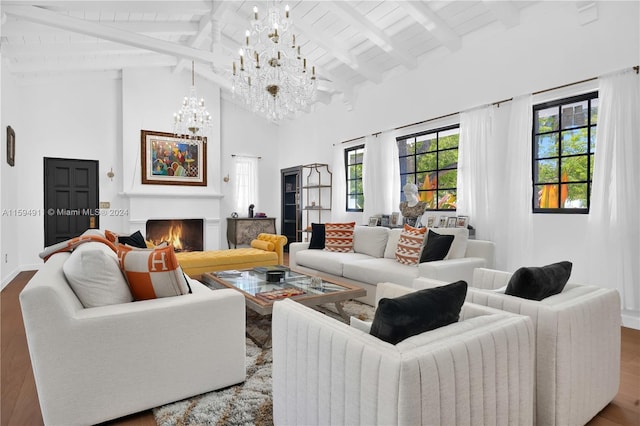 living room featuring beamed ceiling, wood-type flooring, and high vaulted ceiling