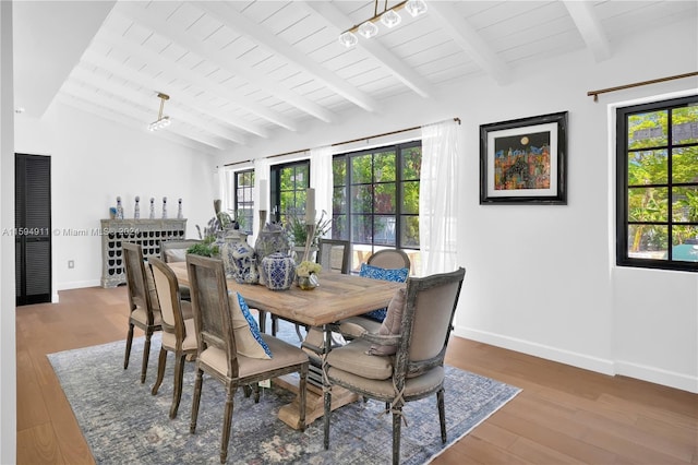 dining room with hardwood / wood-style floors, beamed ceiling, and wood ceiling