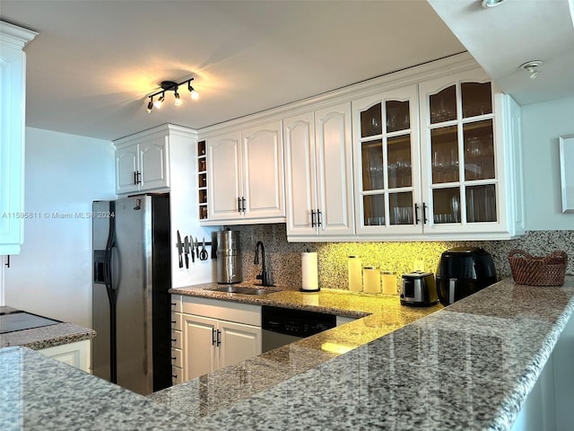 kitchen featuring rail lighting, light stone countertops, white cabinets, sink, and appliances with stainless steel finishes