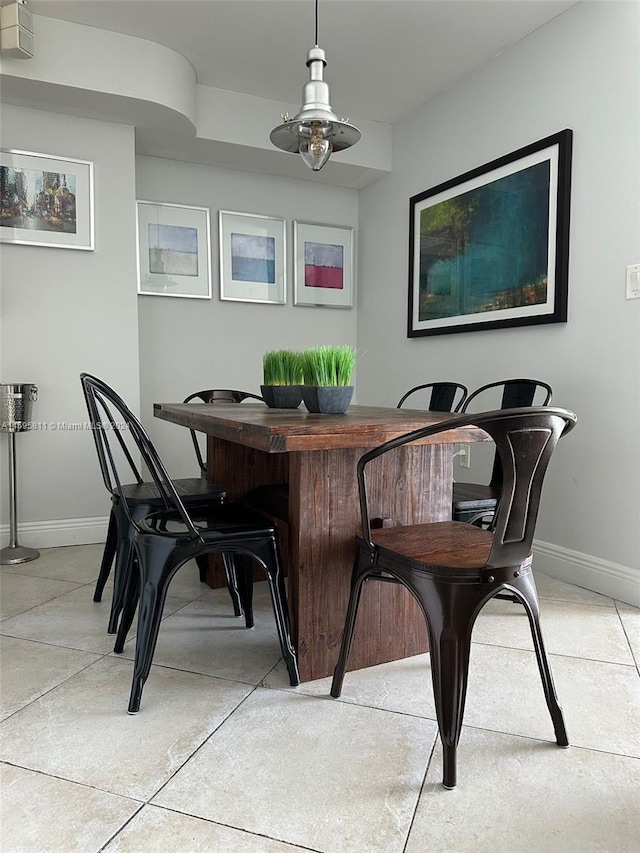 tiled dining area featuring ceiling fan