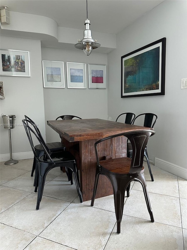 dining area with baseboards and light tile patterned floors