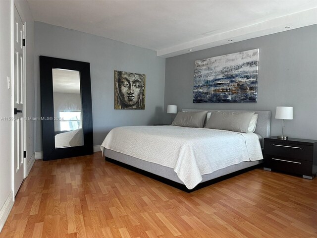 bedroom with baseboards and light wood-type flooring