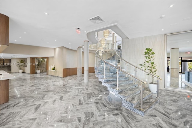 staircase featuring decorative columns