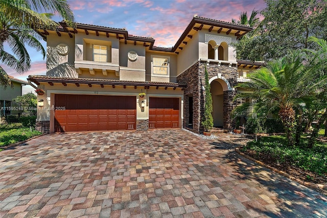 mediterranean / spanish home featuring a garage