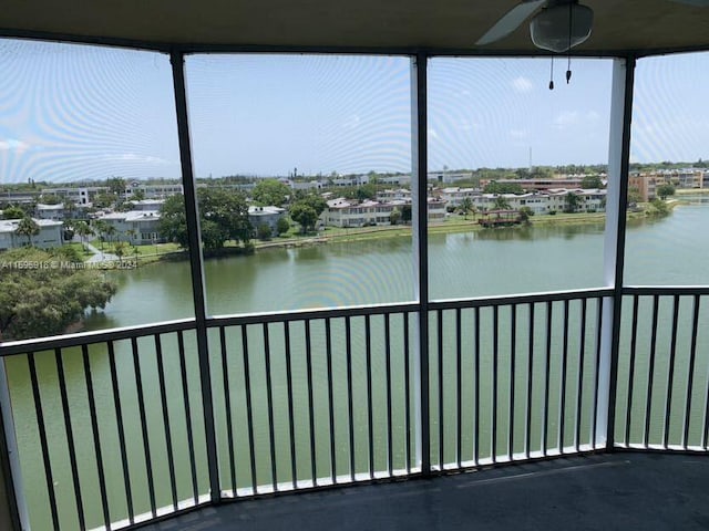 unfurnished sunroom featuring a water view