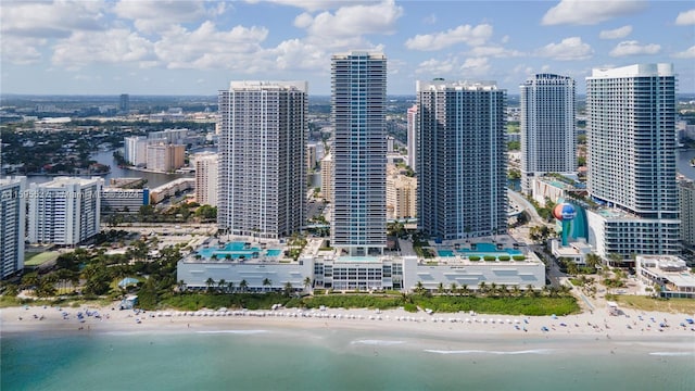 view of city featuring a beach view and a water view