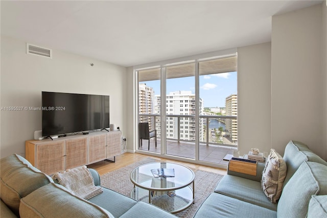 living room with light hardwood / wood-style flooring and expansive windows