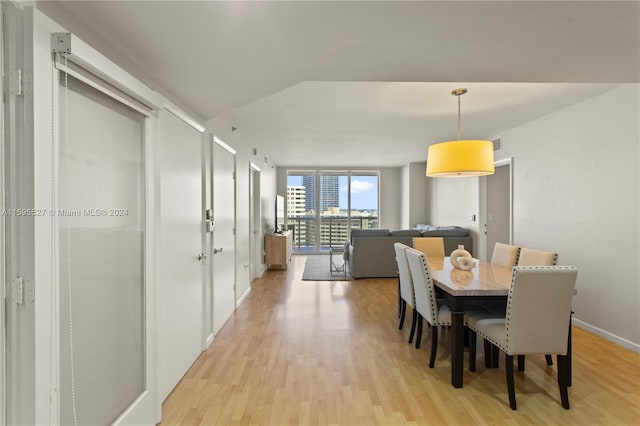 dining space with light hardwood / wood-style flooring and floor to ceiling windows