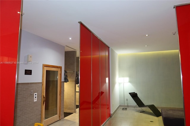 hall featuring light tile patterned floors