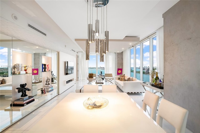 dining area featuring a water view and expansive windows