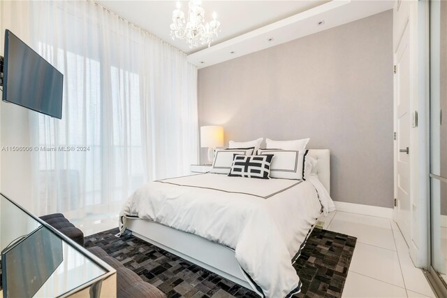 tiled bedroom featuring a chandelier