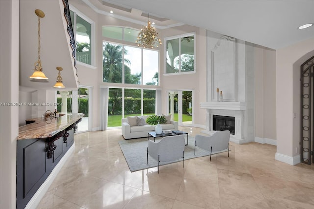 living room with a high ceiling and a large fireplace