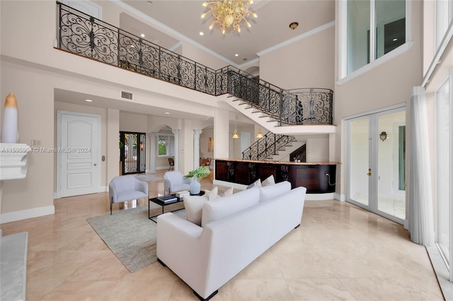 living room featuring french doors, crown molding, and a healthy amount of sunlight