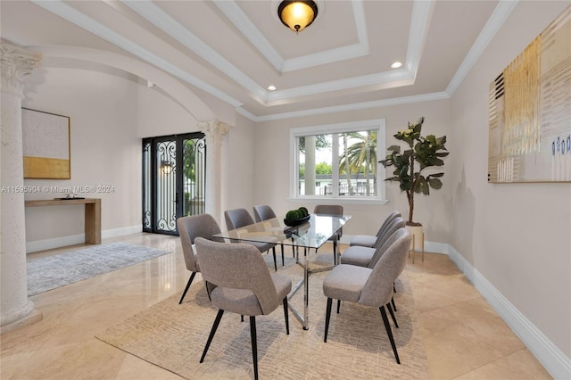 dining area with crown molding, ornate columns, light tile patterned floors, and a tray ceiling