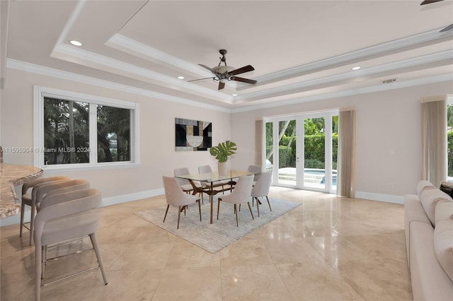 dining room featuring a raised ceiling, ceiling fan, ornamental molding, and french doors