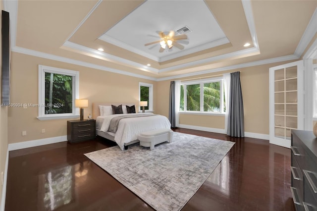 bedroom with crown molding, a raised ceiling, dark hardwood / wood-style flooring, and ceiling fan