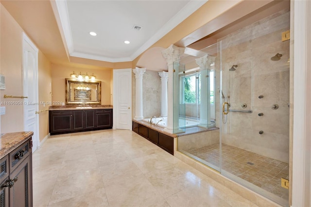 bathroom with plus walk in shower, vanity, crown molding, and ornate columns