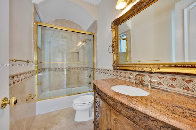 full bathroom featuring tile patterned flooring, backsplash, toilet, bath / shower combo with glass door, and vanity