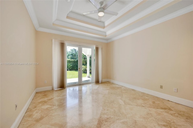 spare room featuring ceiling fan, a raised ceiling, crown molding, and french doors