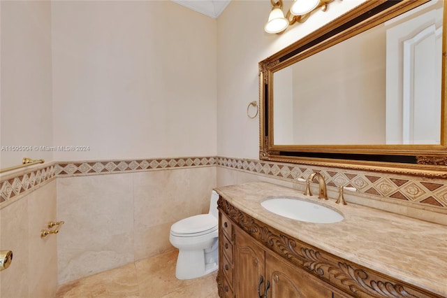 bathroom featuring tile patterned flooring, backsplash, toilet, tile walls, and vanity