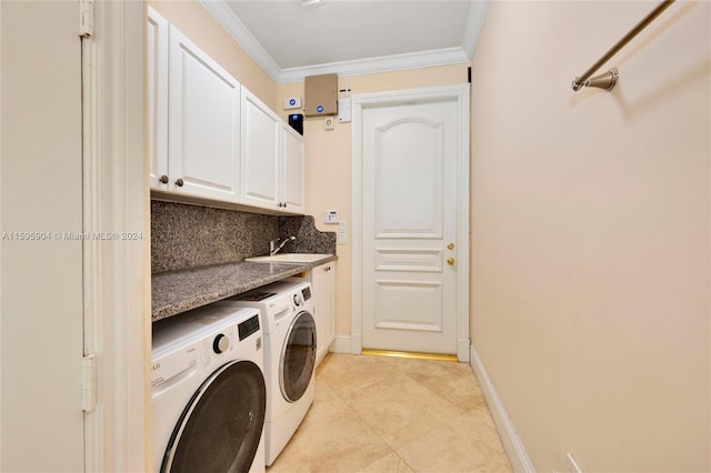 clothes washing area featuring washer and dryer, cabinets, ornamental molding, and light tile patterned flooring