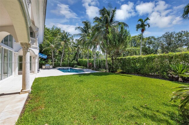 view of yard featuring a fenced in pool and a patio area