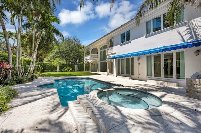 view of swimming pool featuring a patio and an in ground hot tub