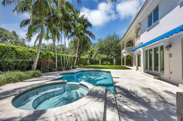 view of swimming pool with a patio area and an in ground hot tub