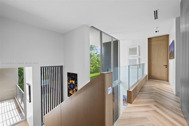 corridor featuring light parquet flooring