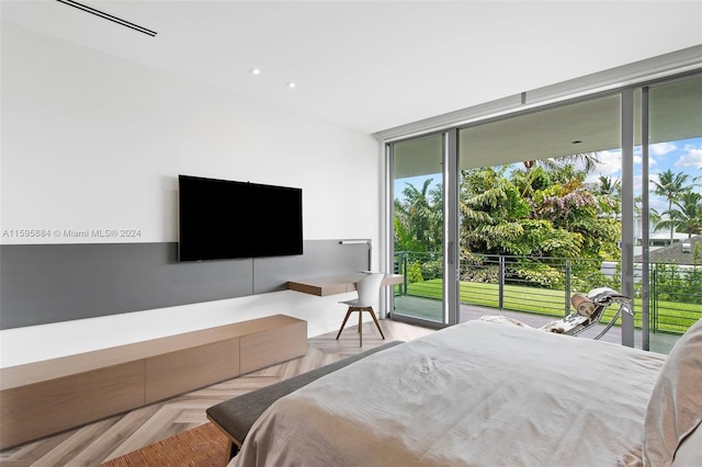 bedroom with expansive windows, access to exterior, and light parquet floors