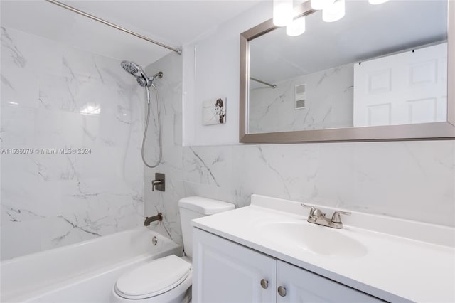 full bathroom with tile walls, backsplash, toilet, tiled shower / bath combo, and vanity