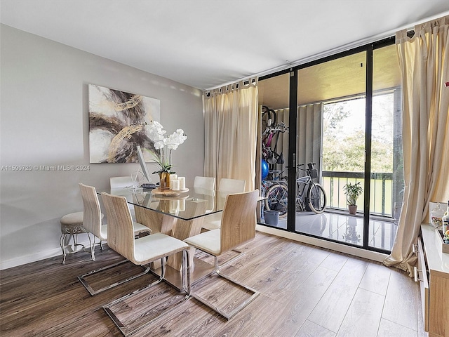 dining room featuring a barn door and hardwood / wood-style flooring