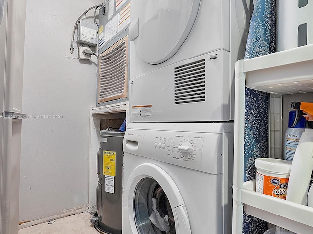 laundry room featuring stacked washer / drying machine