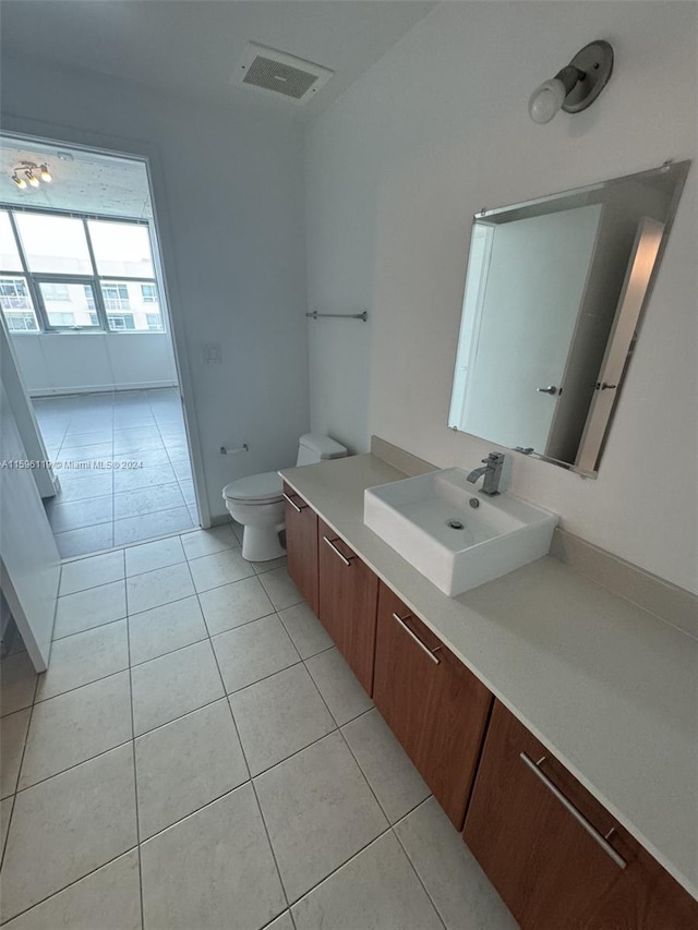 bathroom featuring tile patterned floors, vanity, and toilet