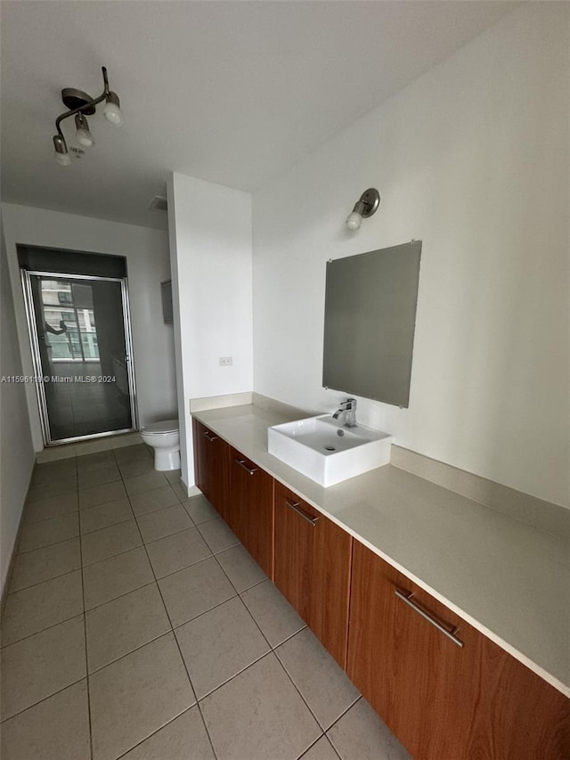 bathroom featuring vanity, tile patterned flooring, and toilet