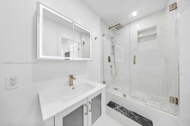 bathroom featuring vanity and a shower with door